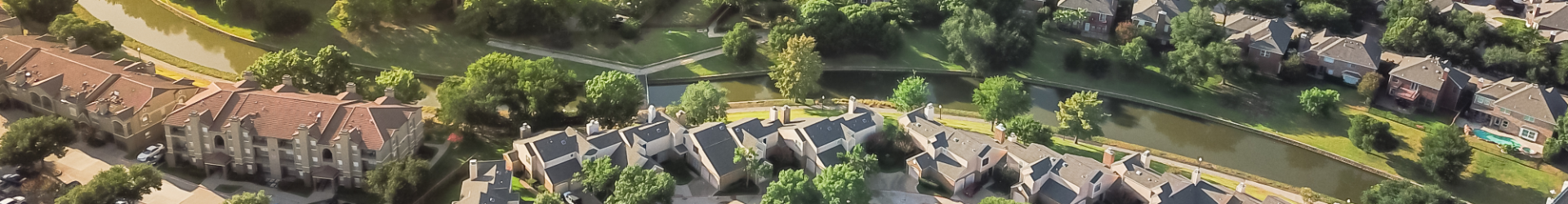 drone shot of homes along a creek