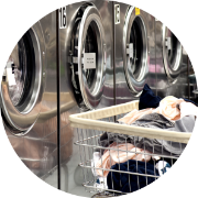 Row Of Washers With Cart Of Clothes